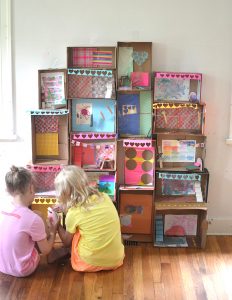 kids make a giant mansion from recycled shoeboxes.