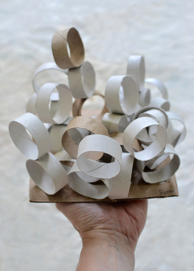 Kids make sculptures from small bits of cut-up cardboard rolls.