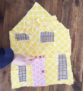 Kids make patchwork houses from cardboard and fabric scraps.