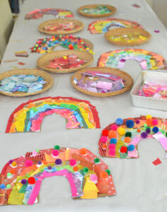 Kids make rainbows from cardboard and collage material.