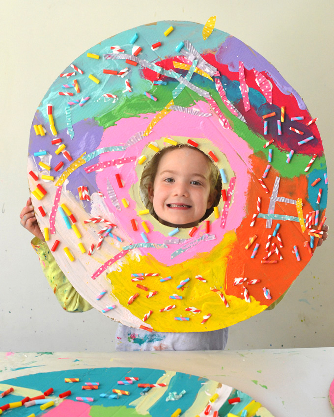 Kids make giant donuts from cardboard.