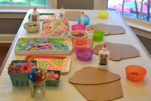 Children make giant cardboard cupcakes with oil pastels and collage, inspired by the artist Wayne Thiebauld.