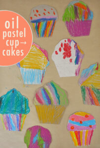 Kids make cardboard cupcakes from cereal boxes with vibrant oil pastels.