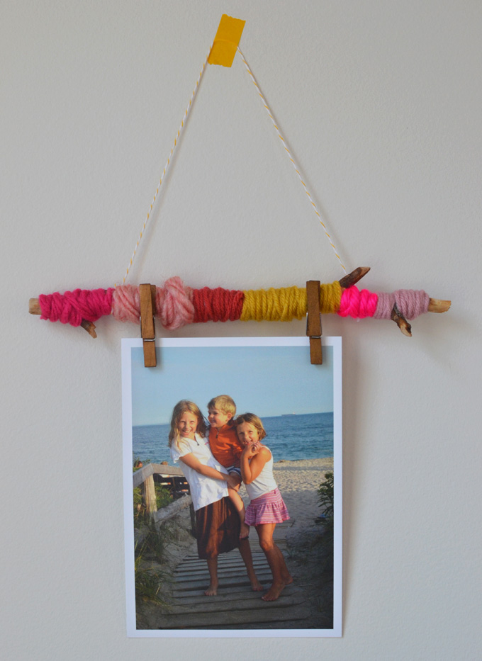 Make easy photo holders to hang on your wall with yarn and twigs.
