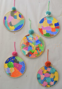 Kids explore acrylics for the first time, using canvas and an embroidery hoop.