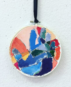 Children use warm and cool paint colors to make this handprint keepsake.