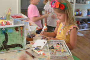 Kids use their imaginations to create adventure boxes with maps and a materials table. A wonderful creative invitation.