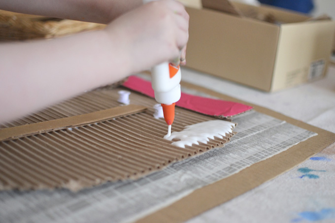 Kids created faces from corrugated cardboard and paint.