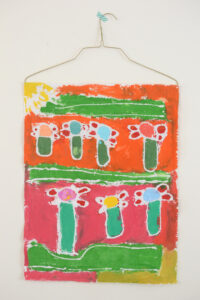 Kids paint with glue on fabric to make batik art, inspired by artist Anna Blatman.