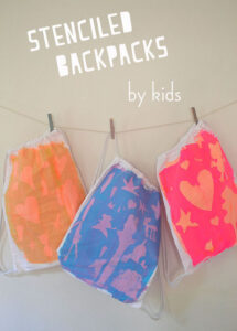 Stenciled backpacks with kids.