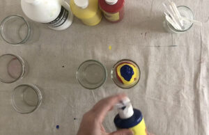 Using primary color tempera paints to mix skin tones for art class.