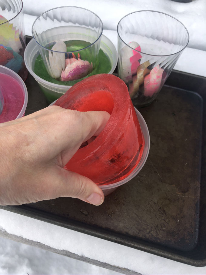 Make simple ice votives by freezing water overnight in a deli container and adding some food coloring. A beautiful addition to your outdoor, pandemic party!