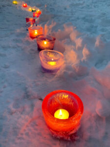 Make simple ice votives by freezing water overnight in a deli container and adding some food coloring. A beautiful addition to your outdoor, pandemic party!