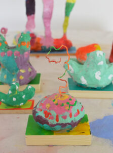 Children make paper mâché sculptures inspired by the artist duo Chiaozza.