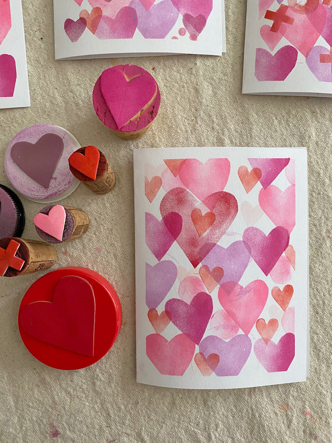 Make Valentine's cards with homemade stamps made with craft foam, corks, and lids.
