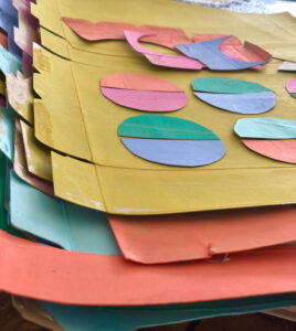 Make a simple egg garland with painted cereal box cardboard.