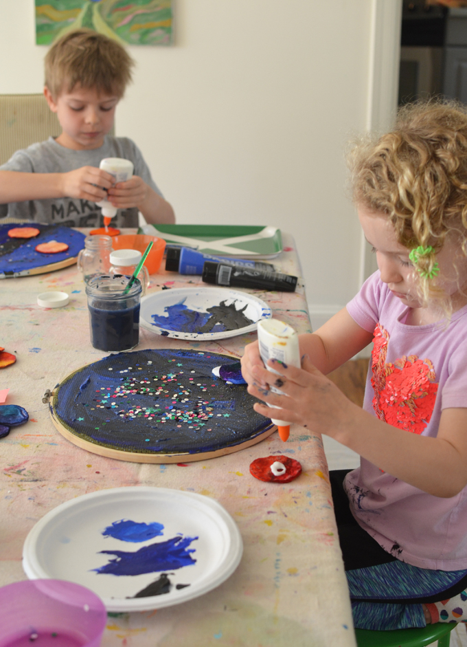 Make a solar system with cotton rounds, watercolor, acrylics, fabric and an embroidery hoop. A wonderful, open-ended art activity to celebrate Earth day!