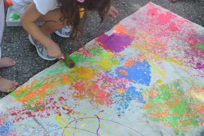 Jackson Pollock artist study with kids, large scale collaborative painting.