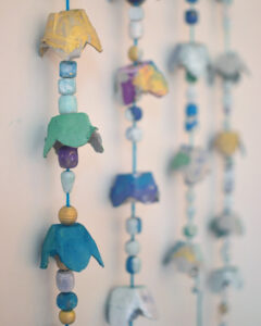 Make beautiful, dangly chimes from egg cartons and beads.