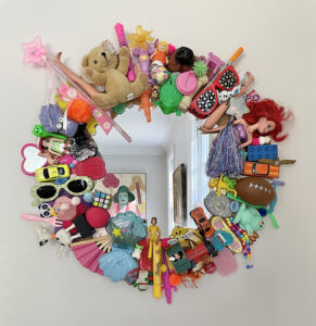 Make a junk toy mirror with upcycled toys.