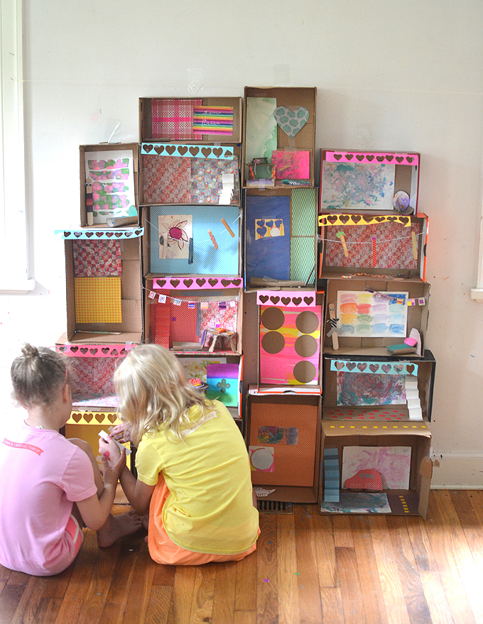 Kids make a giant dollhouse from shoeboxes.