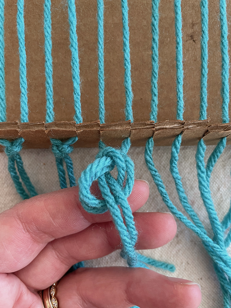 Make a cardboard loom for weaving with kids, attaching the warp