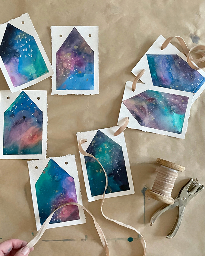 Make a house garland using liquid watercolor and watercolor paper.