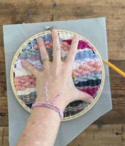 Tracing a pice of felt to glue onto the back of the embroidery hoop round weaving