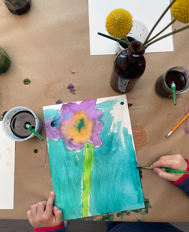Observational flower still-life drawing by young child using liquid watercolor.