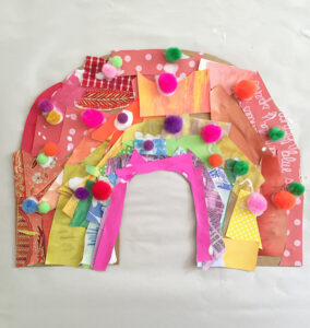 Children make a rainbow collage on cardboard.