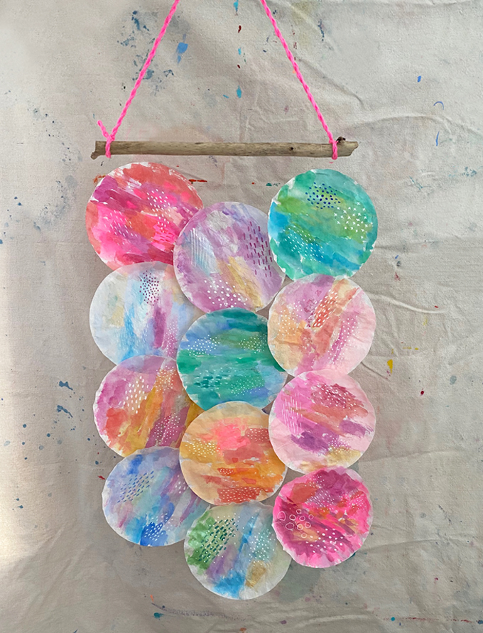 Paint coffee filters with watercolor and create a wallhanging with a stick.