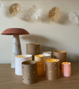 Make paper luminaries with hole punchers and battery tea lights.