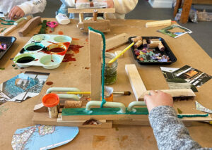 Children used soft yarns and magazine clippings to embellish and compliment their wood structures.