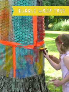 Wrapping bubble wrap around a tree to use for printmaking with kids.