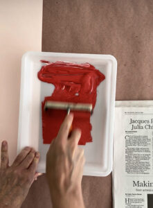 Rolling out printing ink on a tray with a brayer, getting ready to print with styrofoam.