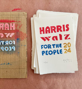 Harris Walz handmade prints in a stack next to a printing plate