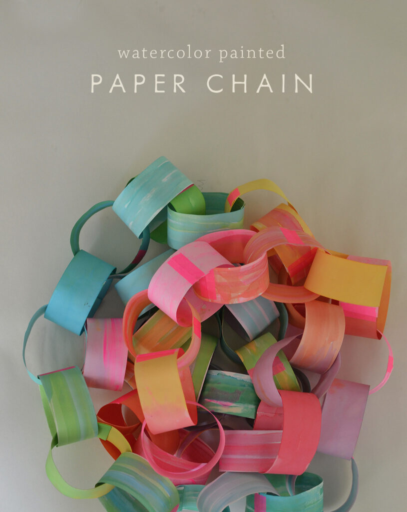 Make a colorful, rainbow paper chain using hand painted paper and neon tape.