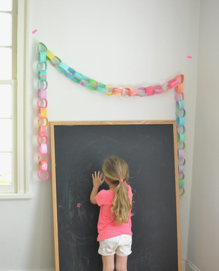 Make a colorful, rainbow paper chain using hand painted paper and neon tape.